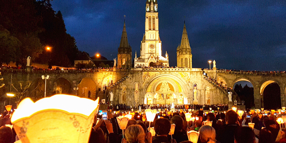 Attending a Candlelight procession in the evening